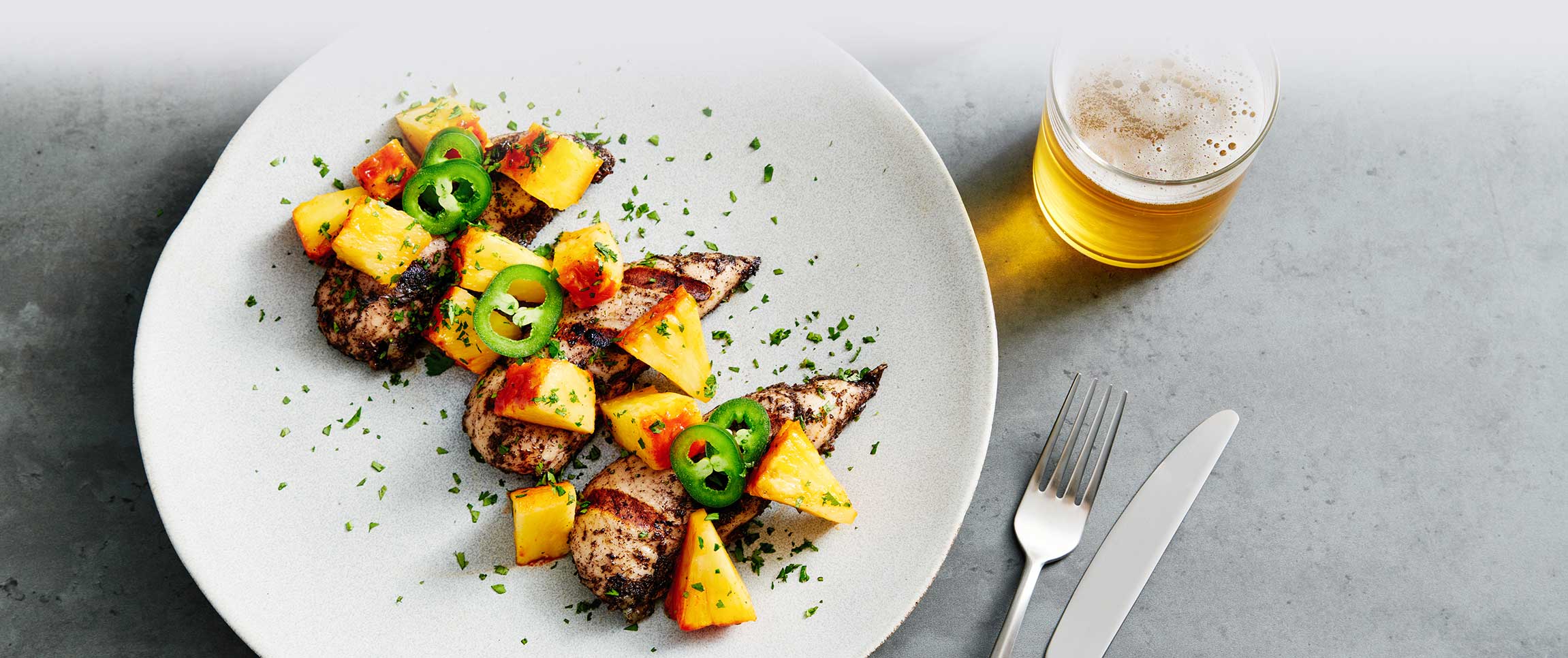 Jerk Farm Smart® Chicken with Cranberry Coconut Sauce over a Chili and Brown Sugar Roasted Pineapple