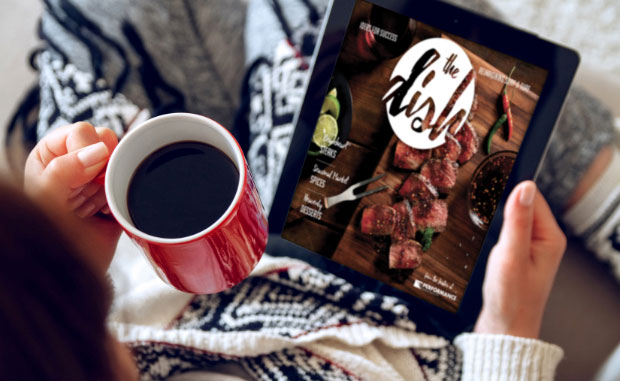 Woman Reading a DISH publication with a cup of coffee