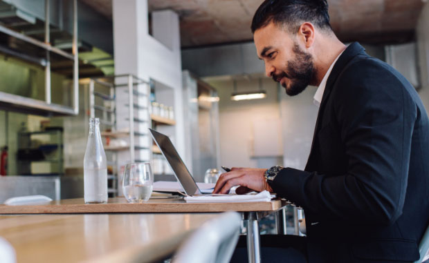 Man sitting at a laptop tracking his online order