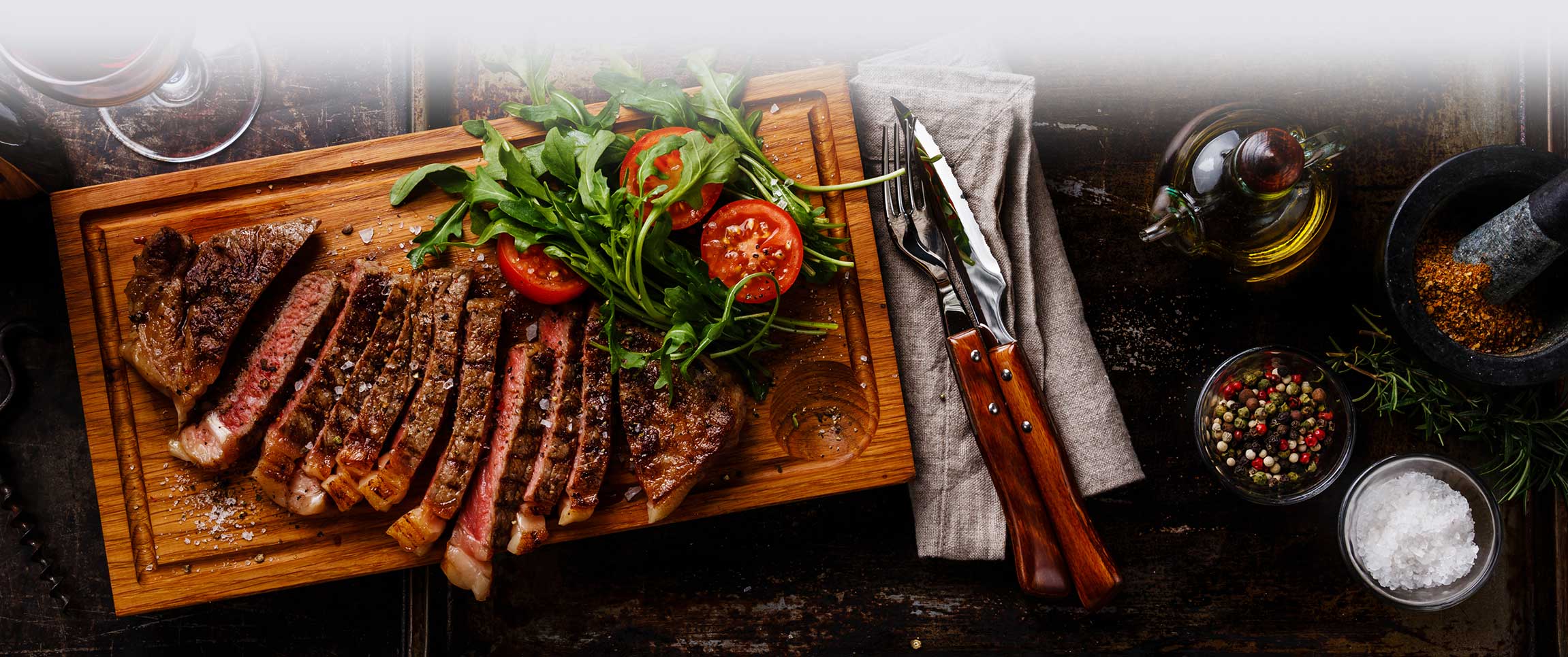 Sliced steak on a wooden cutting board