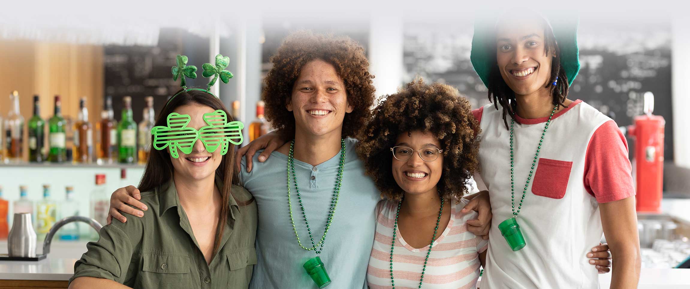 Group of friends celebrating St. Patrick's Day at a bar