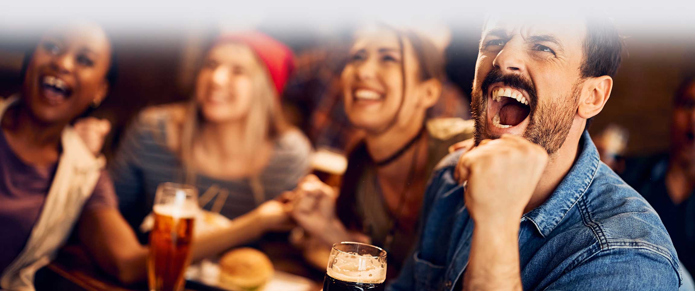 Man celebrating while watching sports at a restaurant