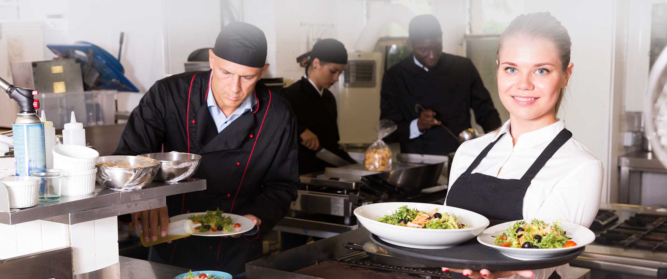 Restaurant Worker Handing Food Plates to a Food Runner