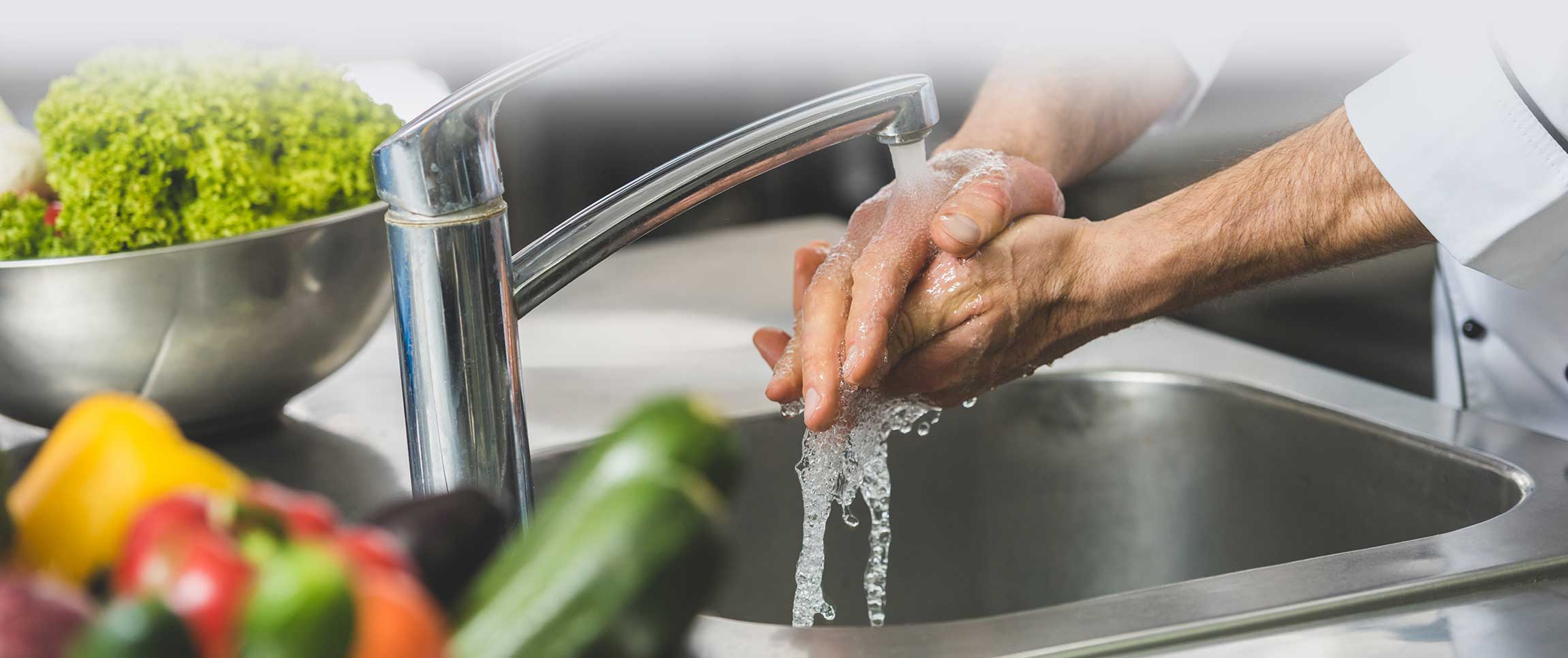 Chef Washing his hands before preparing vegetables