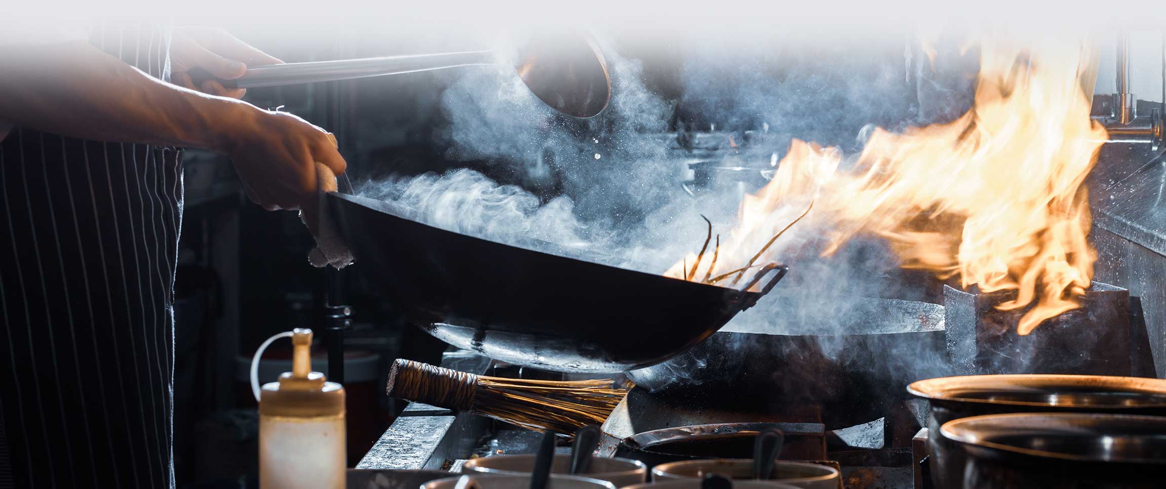 Chef is stirring vegetables in wok