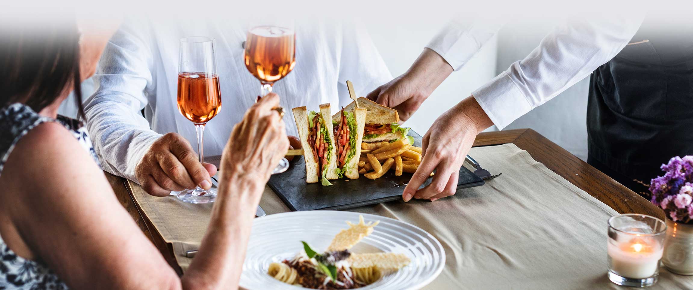 Waiter serving food to restaurant guests