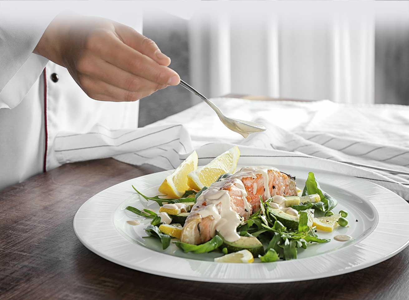 Female Chef Preparing Fish Dish