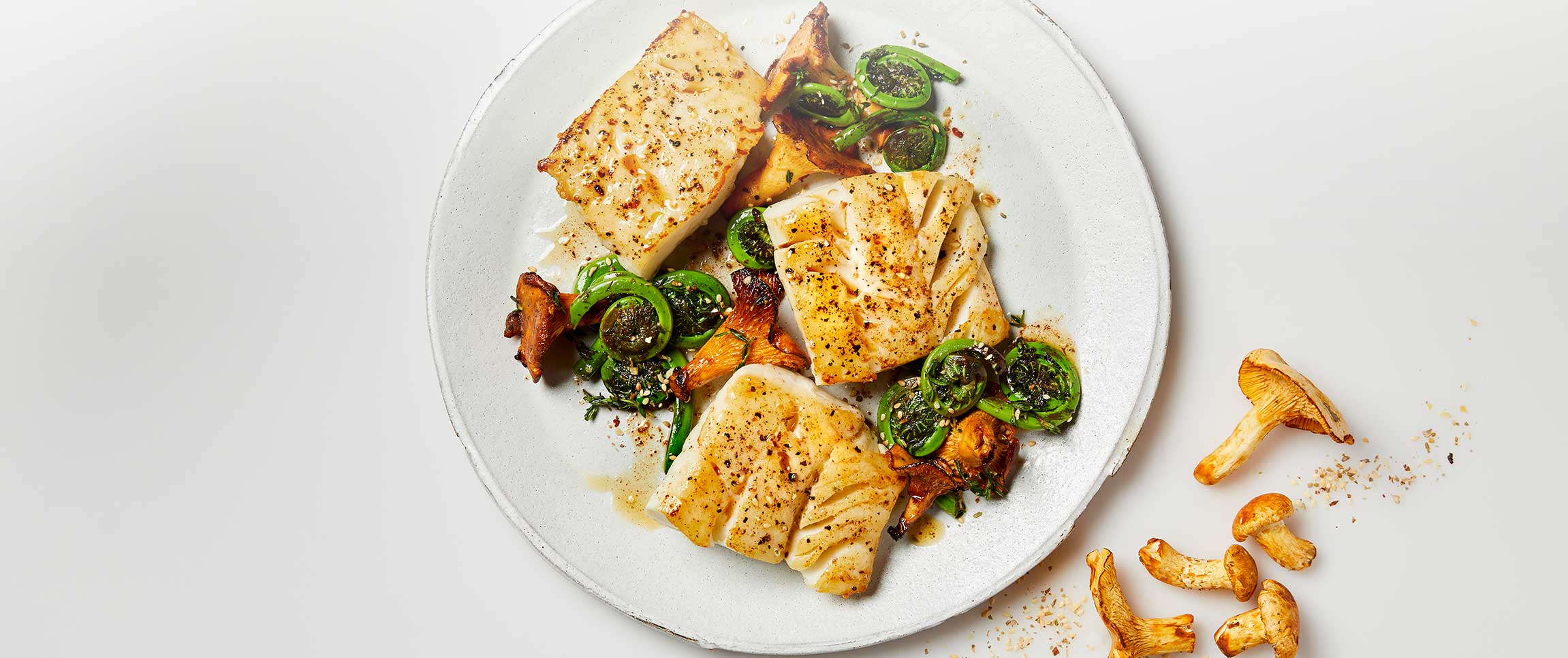 Buttery Dukkah Spiced Alaska Cod with Fiddlehead Ferns and Chanterelles