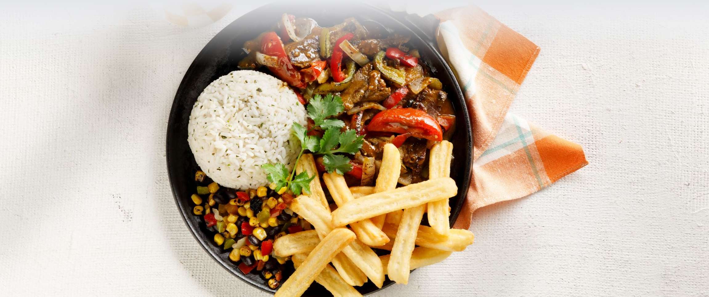 Lomo Saltado with Cilantro Lime Rice, Fries and Fiesta Veggies