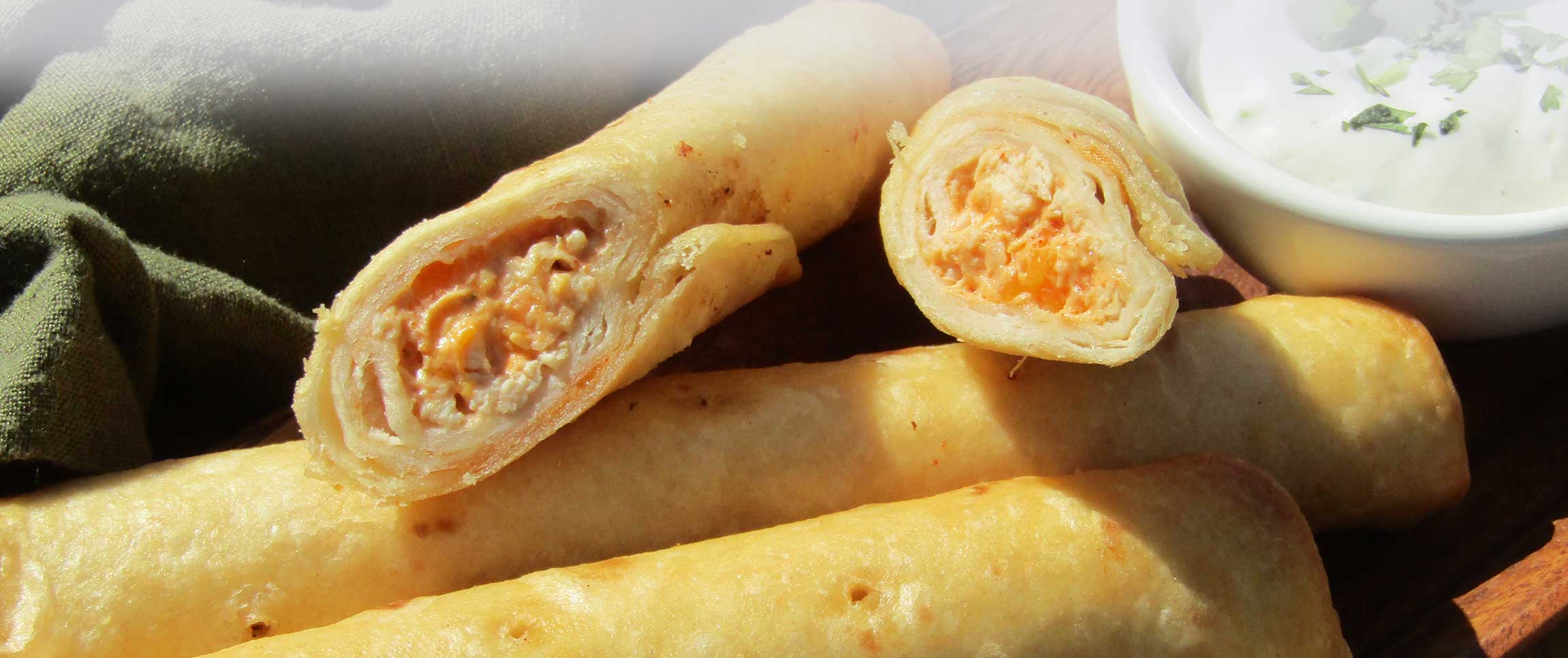 Buffalo Chicken Taquitos with Cilantro Lime Crema