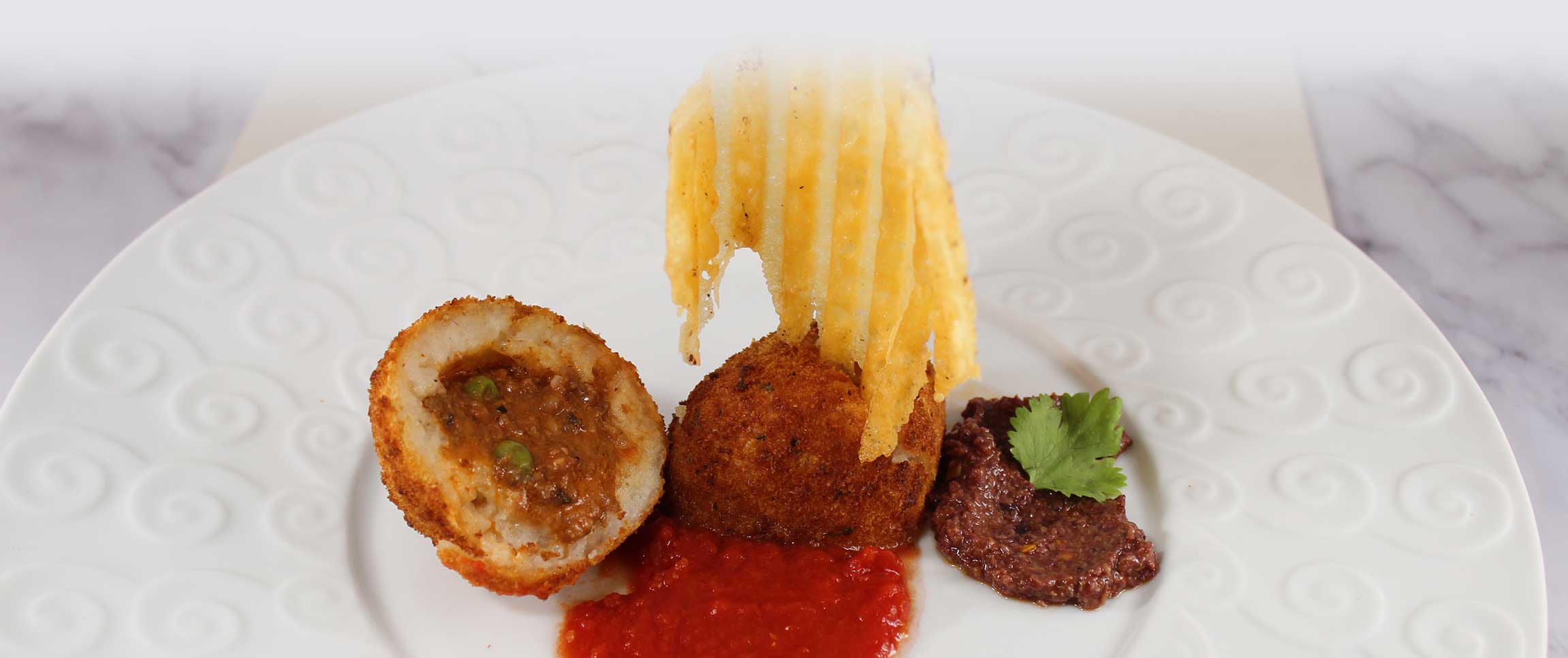 Beef Stuffed Arancini with a Cheese Crisp and Kalamata Tapenade