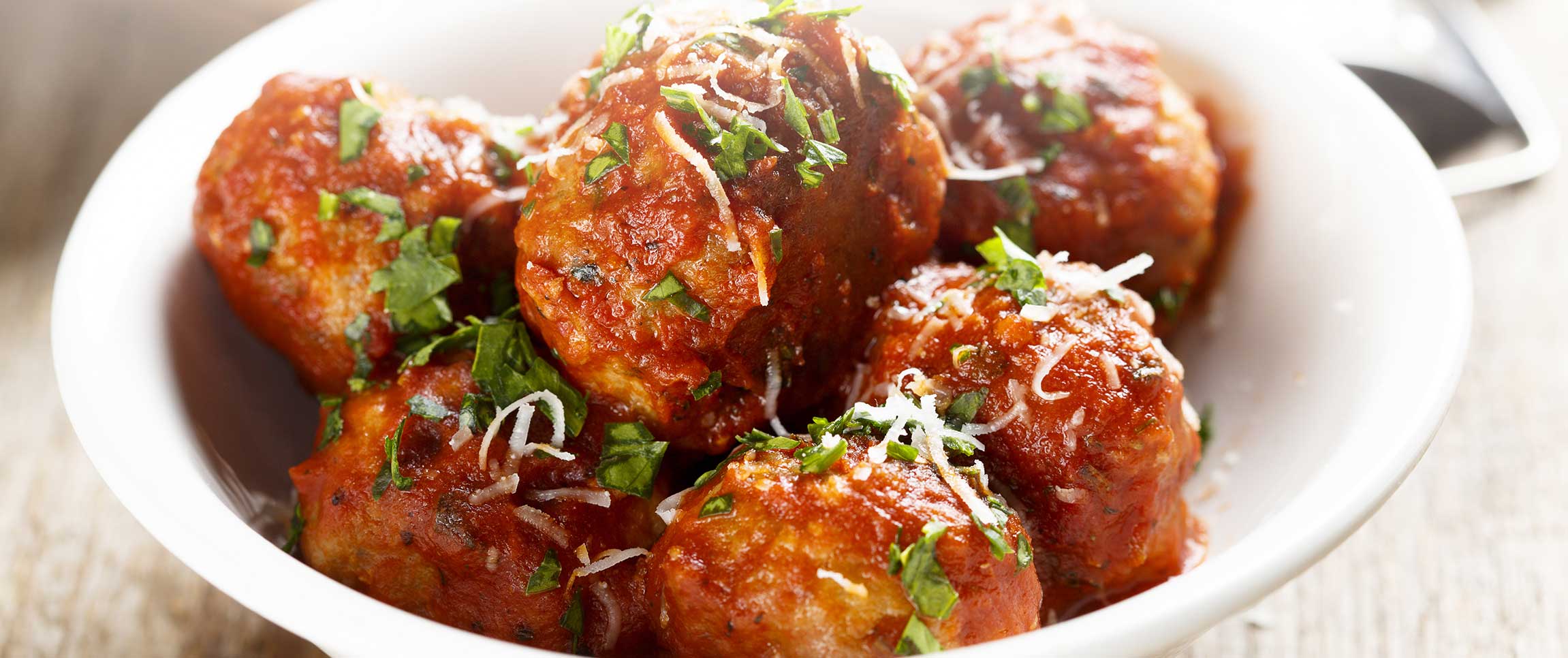 Buffalo Meatballs Topped with Cheese