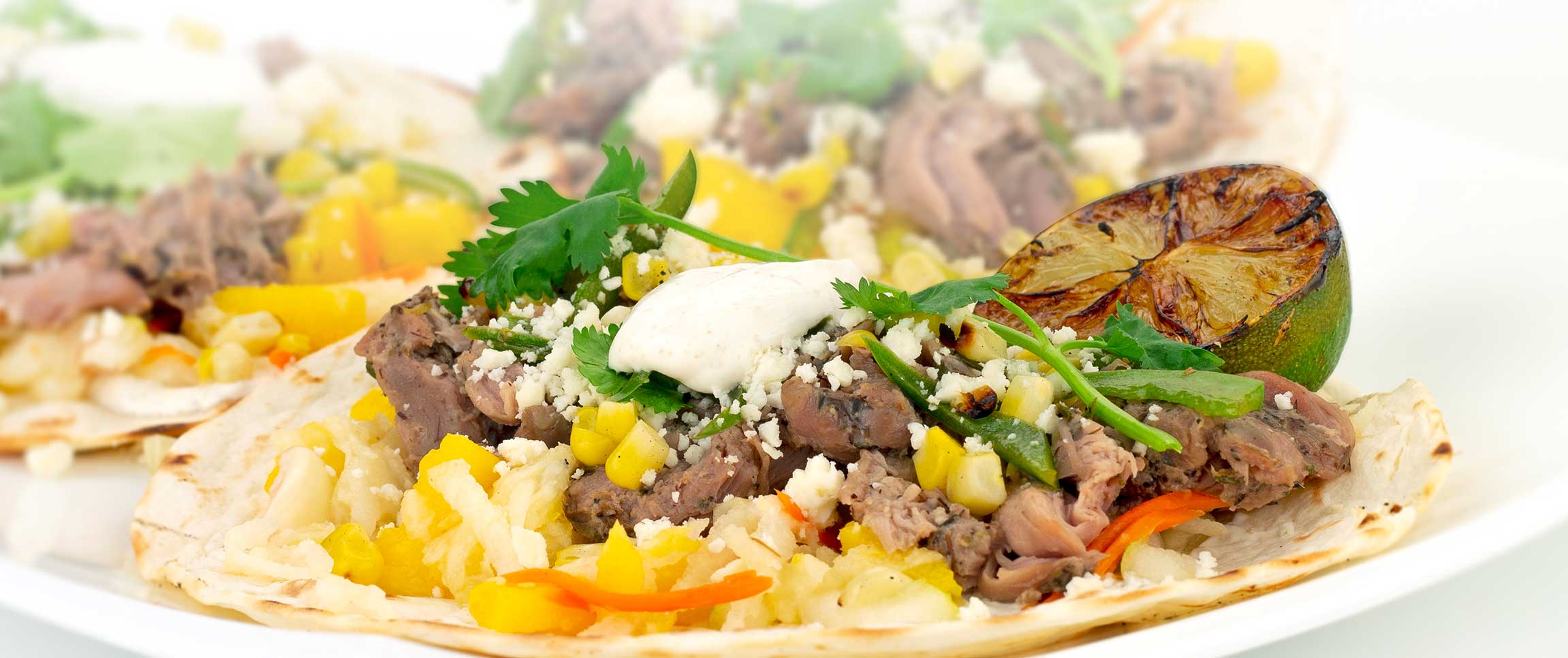 Duck Tacos with Slaw, Mangos, and Cilantro Crema