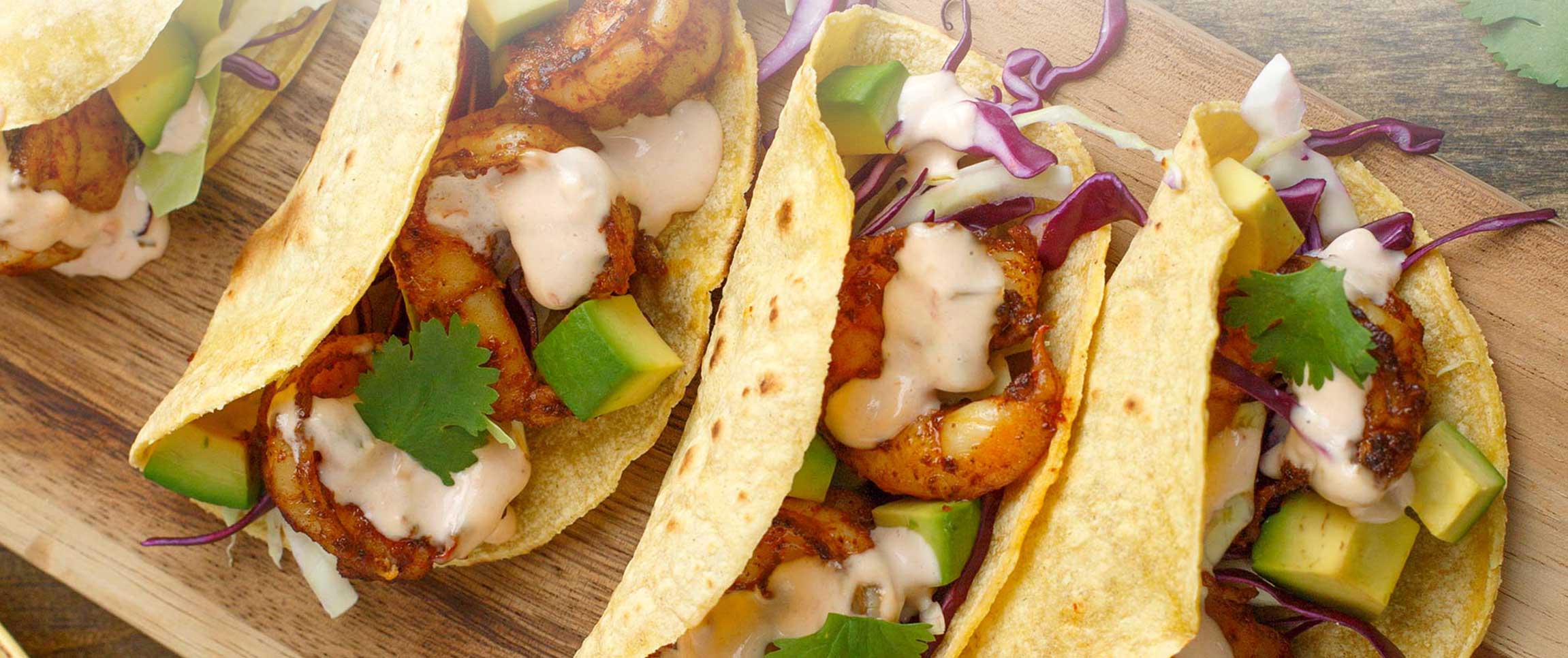 Four Mojito Lime Tacos on a Wooden Board