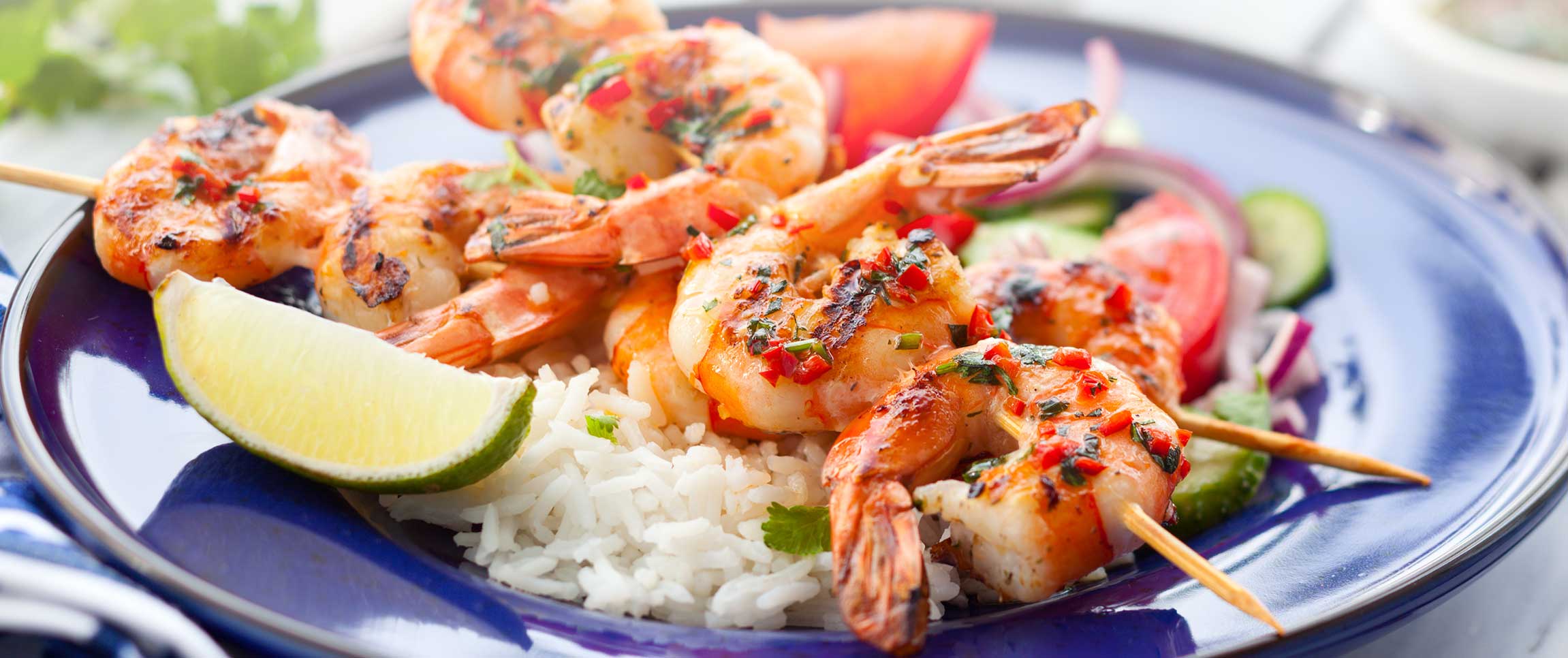 Sweet and spicy shrimp skewers with side of rice