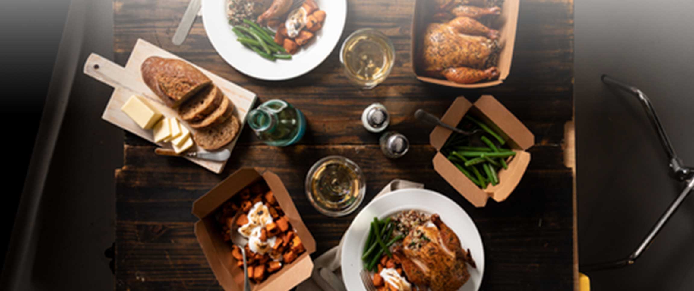 Cornish Game Hen takeout meal on table with side options