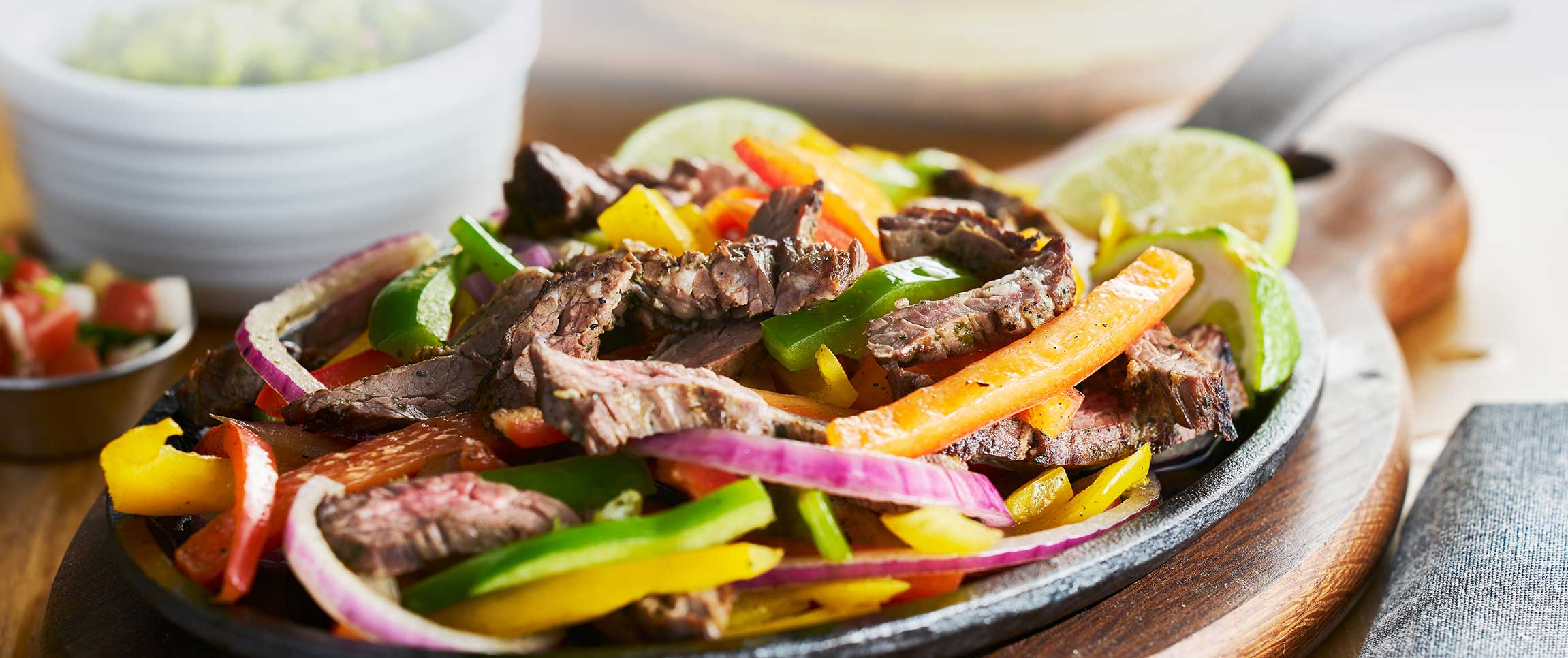 Steak fajitas with guacamole and tortillas