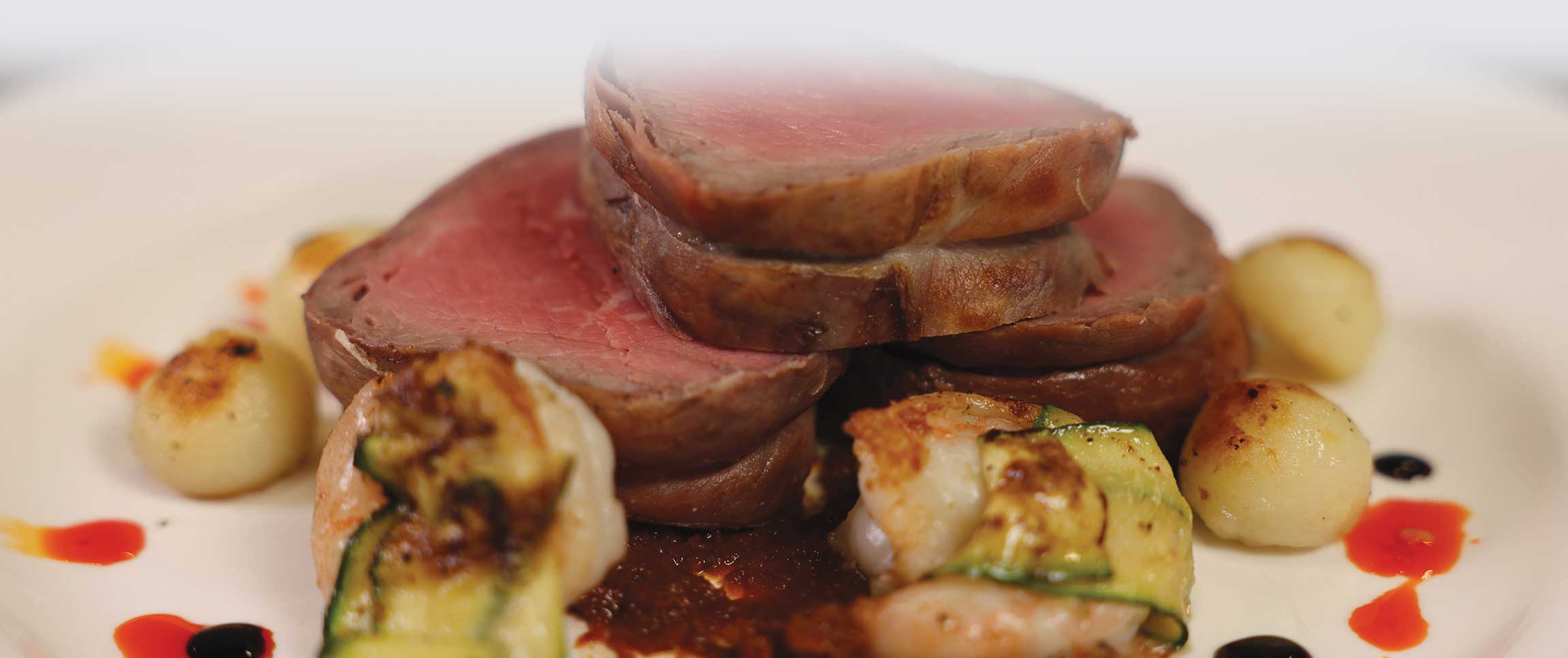 Braveheart Prosciutto Wrapped Tenderloin with Zucchini Wrapper Bay Winds Shrimp