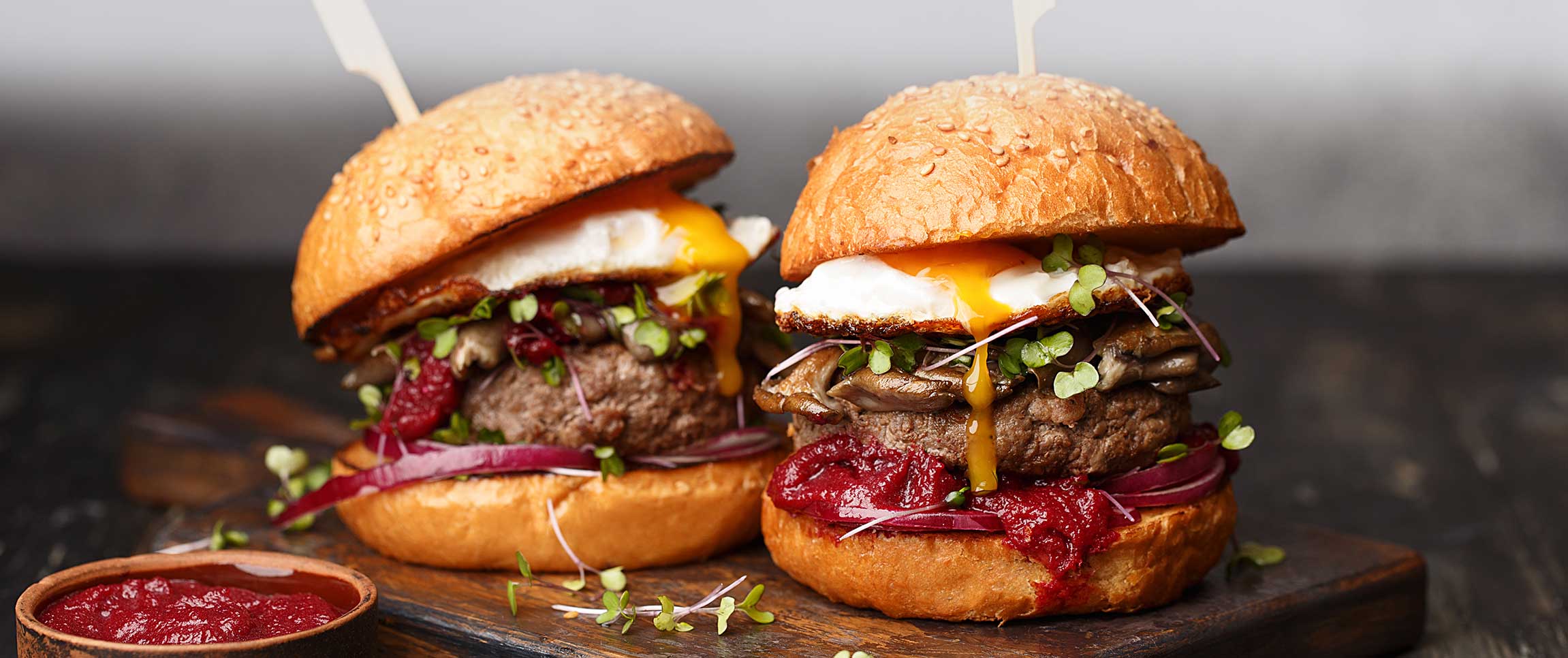 Burger with Roasted Beet Ketchup and Fried Egg on a Sesame Bun