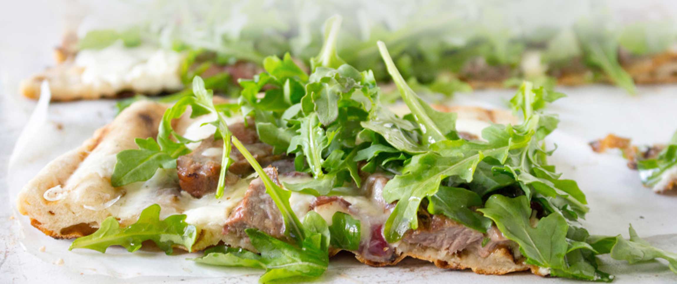 Grilled Skirt Steak Pizza with balsamic red onions and whipped ricotta cheese