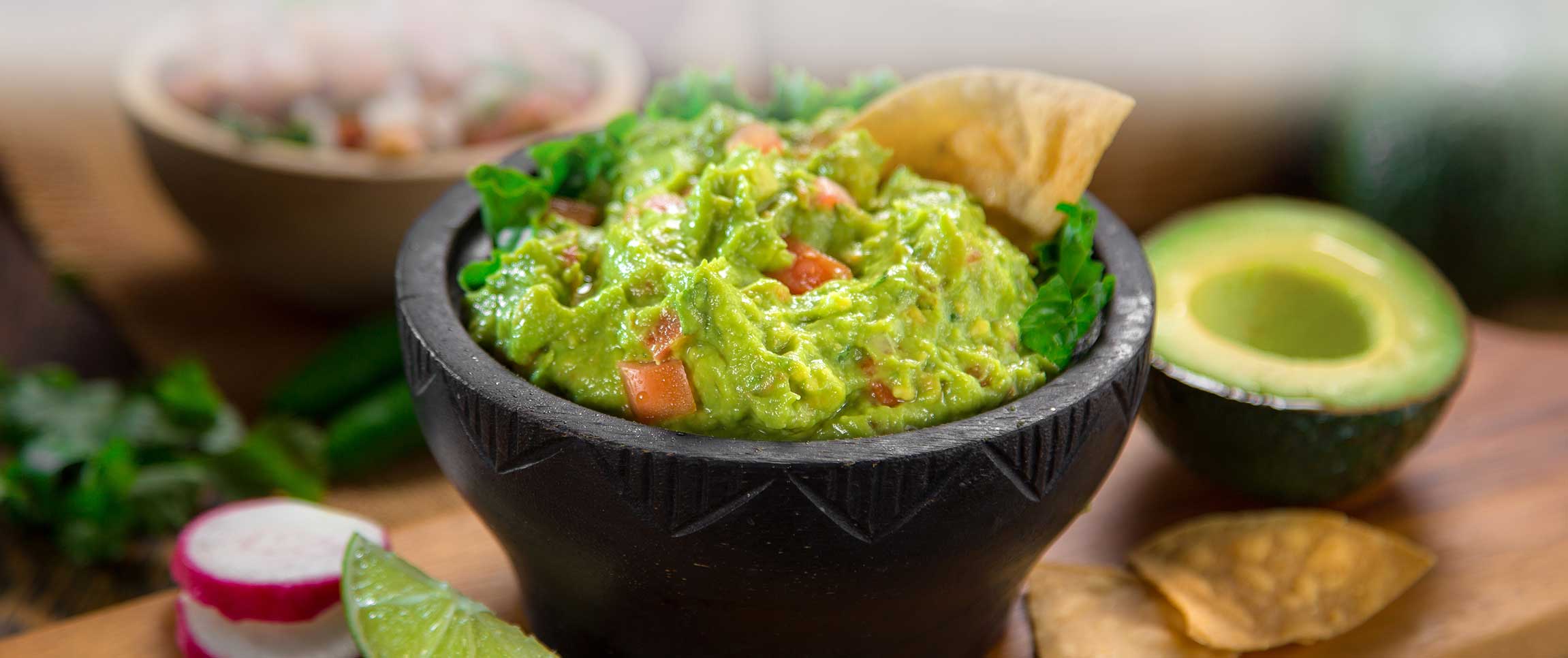 Handmade guacamole with avocado, crisp Peak lime juice, cilantro accompanied by tortilla chips