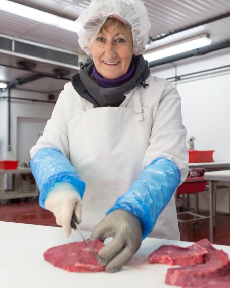 Woman Preparing Raw Meat for Distribution