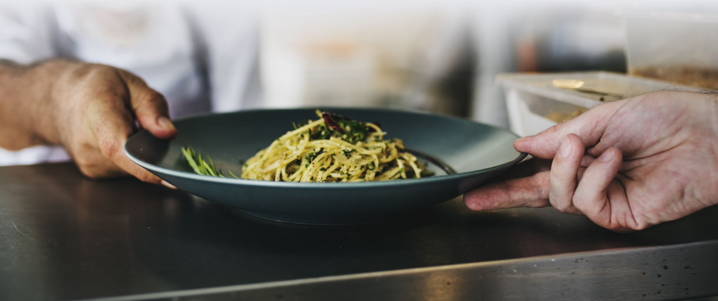 Chef Serving a Plate of Pasta