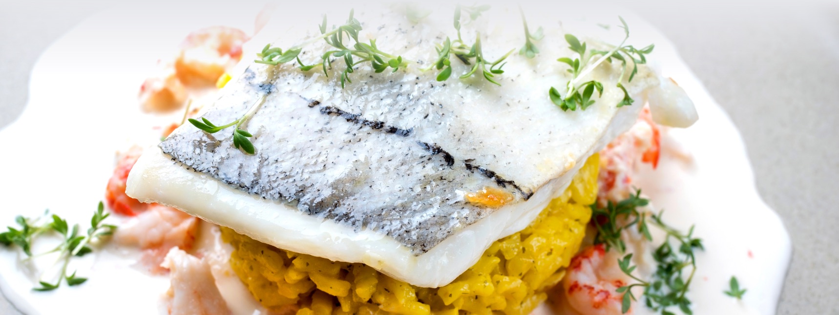 White Fish atop a bed of rice and seafood medly