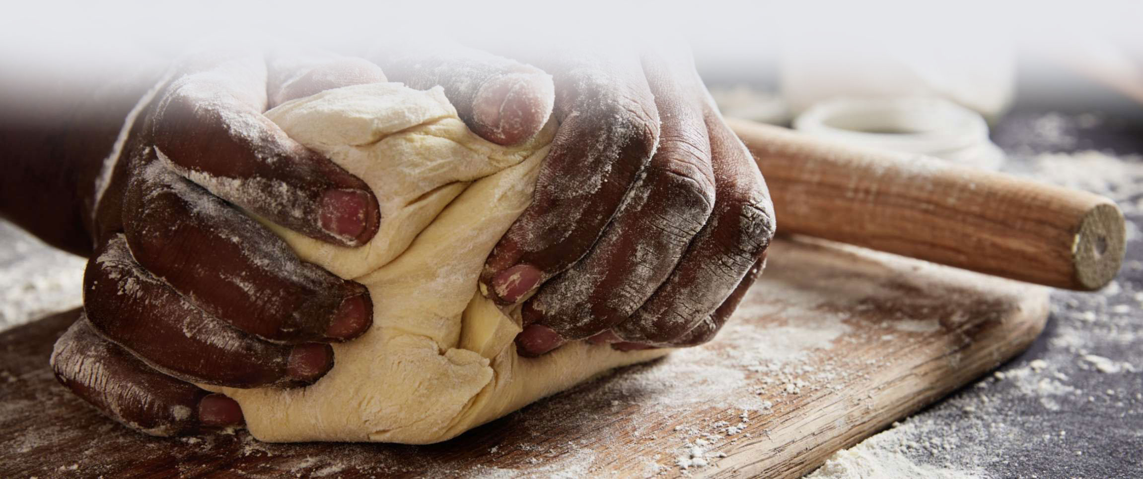 Chef kneading a ball of dough