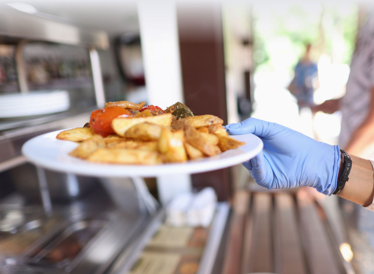 Waiter Serving a Plate of Food