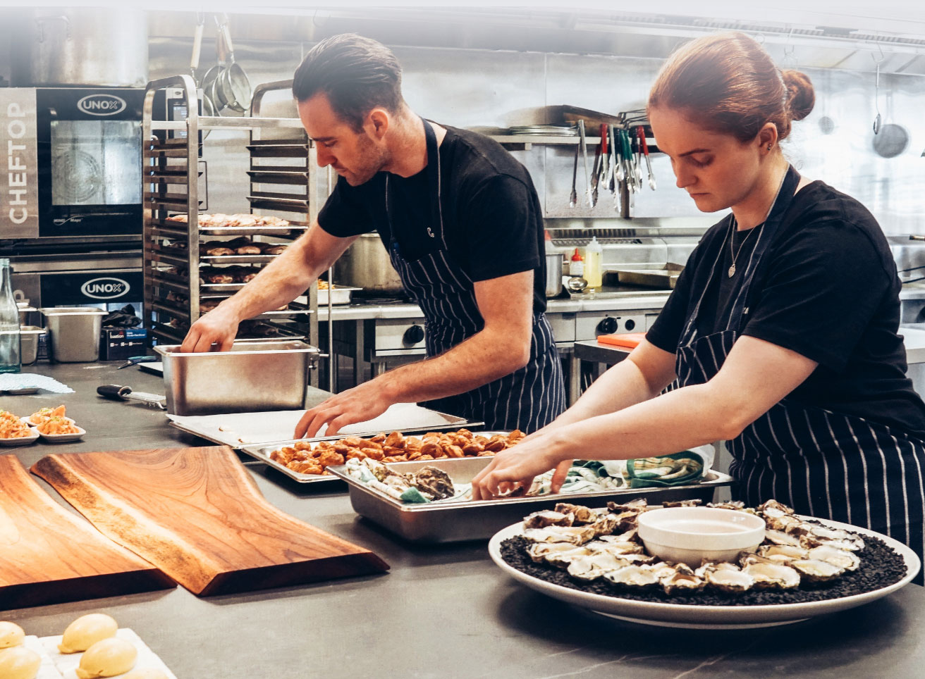 Two Chefs Preparing Appetizers in the Kitchen