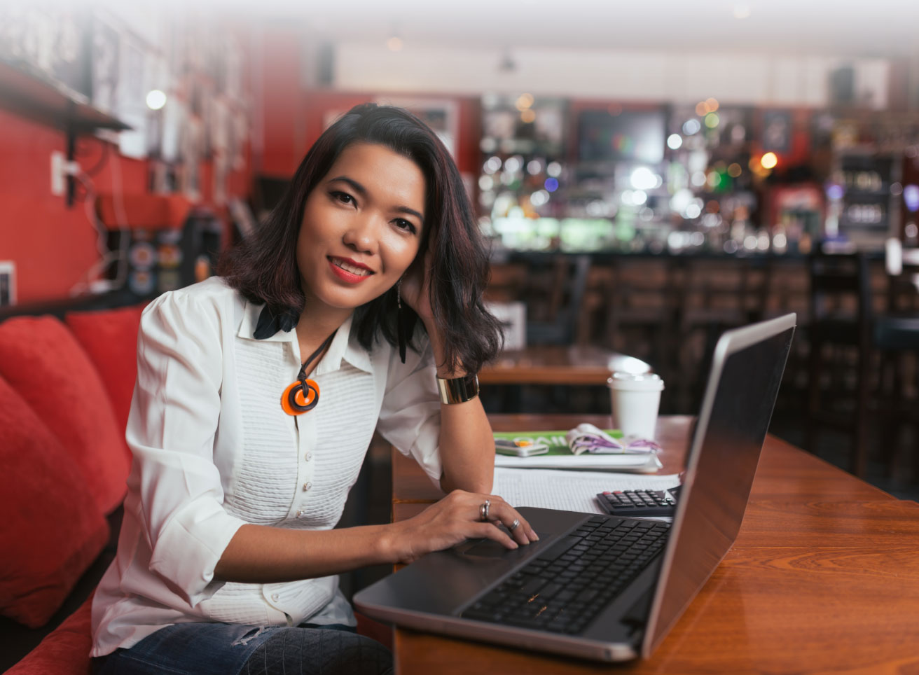 Woman sitting at a laptop smiling