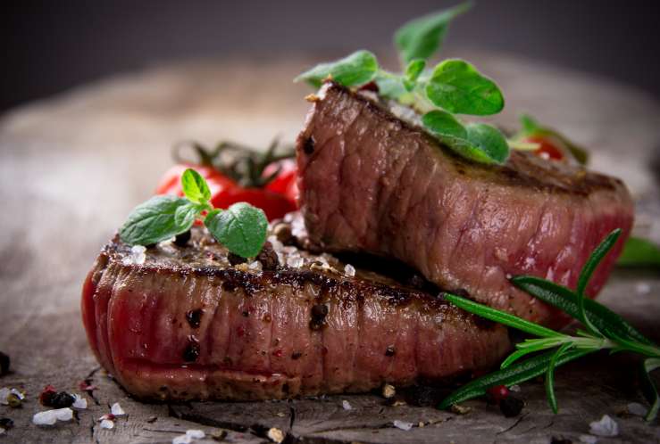 Grilled bbq steaks with fresh herbs and tomatoes
